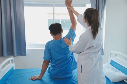 Physiotherapist working with patient in clinic, closeup photo