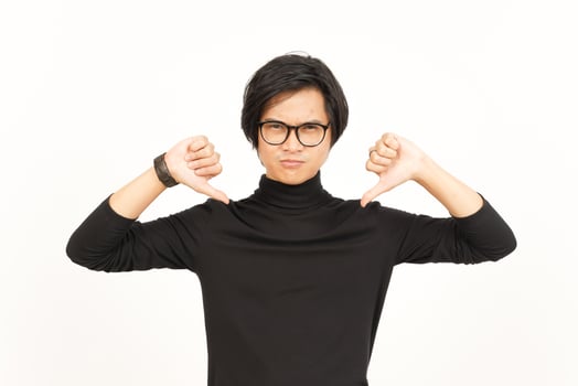 Showing Thumbs Down Of Handsome Asian Man Isolated On White Background photo