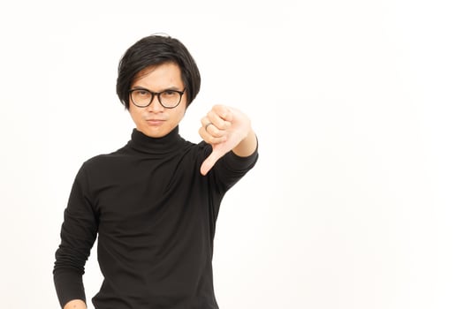 Showing Thumbs Down Of Handsome Asian Man Isolated On White Background photo