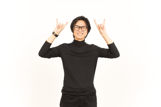 Showing Metal Hand Sign Of Handsome Asian Man Isolated On White Background photo