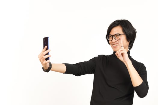 Take a Selfie using Smartphone Of Handsome Asian Man Isolated On White Background photo