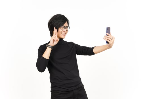 Take a Selfie using Smartphone Of Handsome Asian Man Isolated On White Background photo