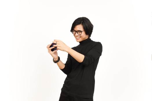 Playing Mobile Game on Smartphone Of Handsome Asian Man Isolated On White Background photo