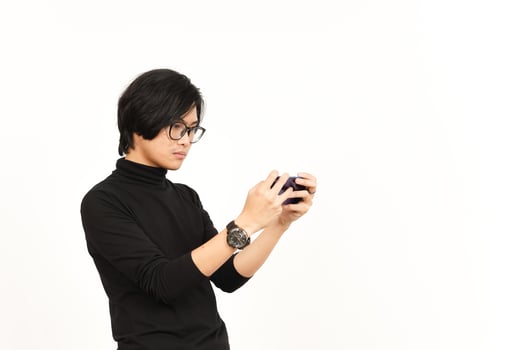 Playing Mobile Game on Smartphone Of Handsome Asian Man Isolated On White Background photo