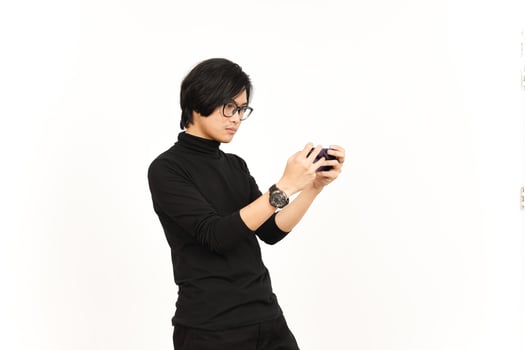 Playing Mobile Game on Smartphone Of Handsome Asian Man Isolated On White Background photo