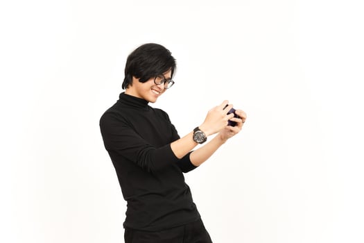 Playing Mobile Game on Smartphone Of Handsome Asian Man Isolated On White Background photo