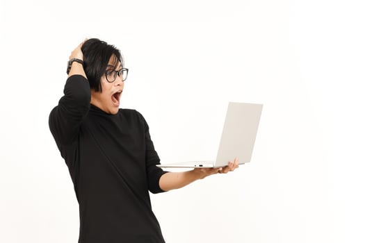 Shock and Angry While Using Laptop Of Handsome Asian Man Isolated On White Background photo
