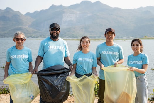 Volunteer group of people for charity donation on river beach. Environmental and ecological care, Earth day concept photo
