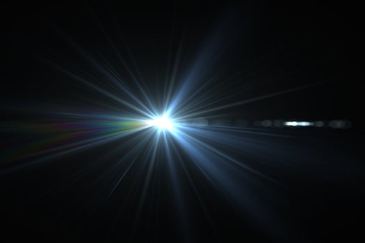 Bright beam of a searchlight on a dark background. Light from a lamp in the dark.Flash photo