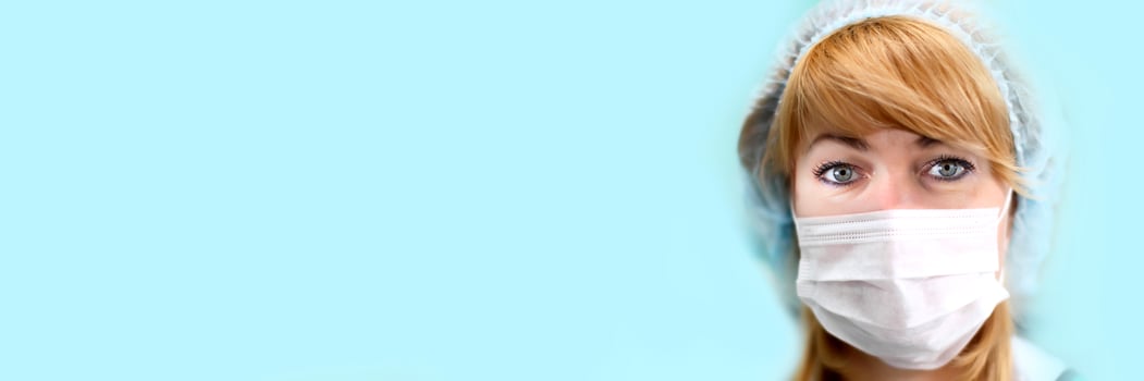 Face of a doctor in a mask and hat.Image of a trainee doctor looking at the camera. photo