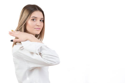 Girl in a white shirt on a white background.Young woman with a smart face. photo