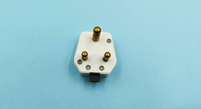 3 pin power plug on blue background photo
