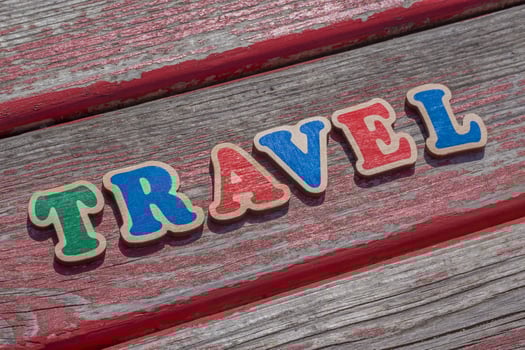 word travel made of color wooden letters on wood board photo
