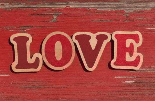 word love on old red wooden board photo
