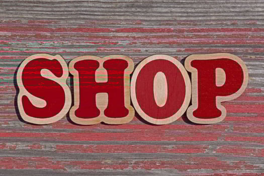 word shop made of wooden letters on aged wooden board photo