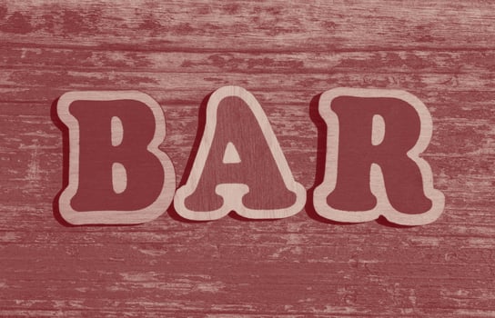 word bar made of wooden letters on wood background photo