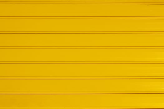 Background texture of horizontal yellow gate panels. Wide and narrow stripes. photo