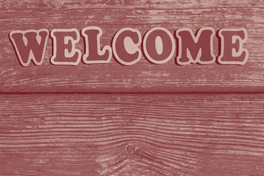 word welcome made of wooden letters on wood background photo