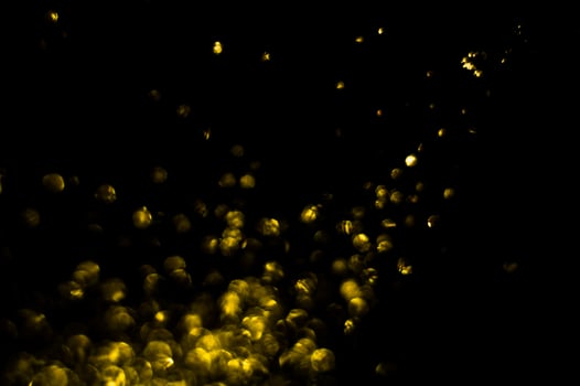 background of abstract glitter lights. gold and black. de focused photo