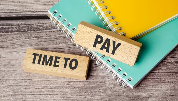 time to pay symbol. Concept words we payday loans on wooden blocks. photo