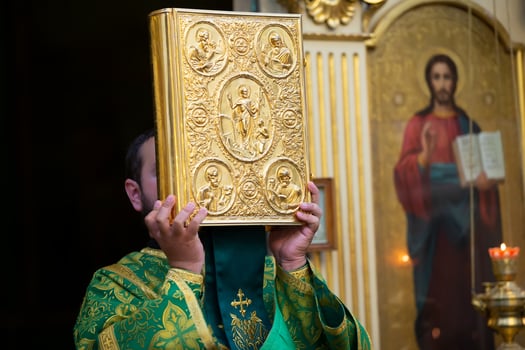 Palm Sunday.Priest with a bible. photo
