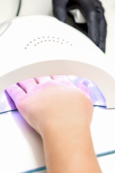 Hand inside of UV lamp photo