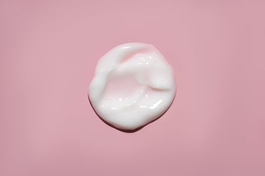 white cream swatch on pink background photo