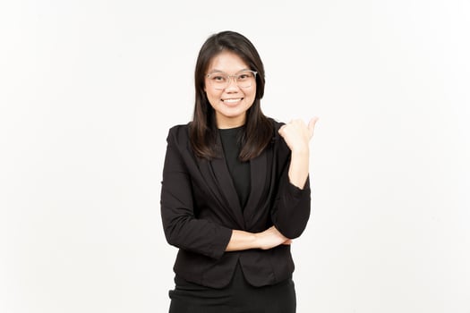 Presenting and Pointing Side Product Using Thumb Of Beautiful Asian Woman Wearing Black Blazer photo
