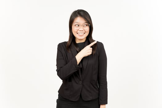 Showing Product and Pointing Side Of Beautiful Asian Woman Wearing Black Blazer Isolated On White photo