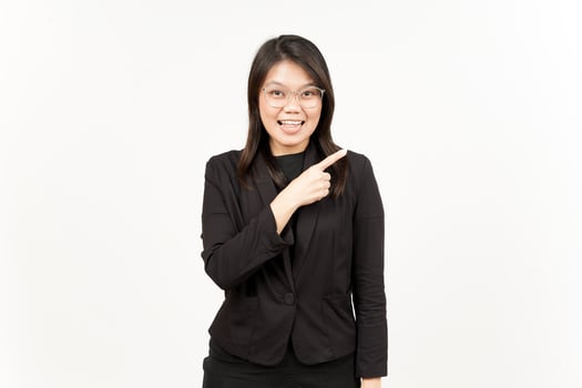 Showing Product and Pointing Side Of Beautiful Asian Woman Wearing Black Blazer Isolated On White photo