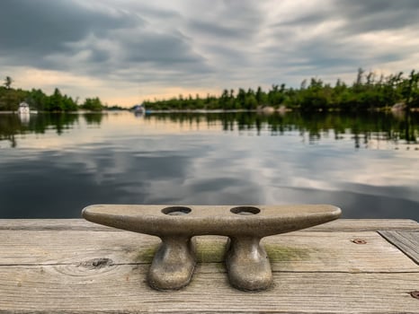Dock cleat on a pier on a tranquil lake photo