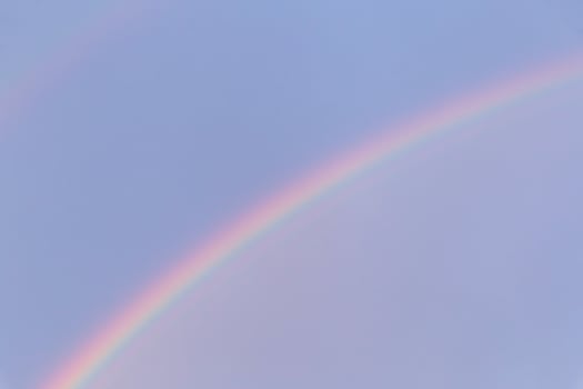 view on rainbow in a blue sky photo