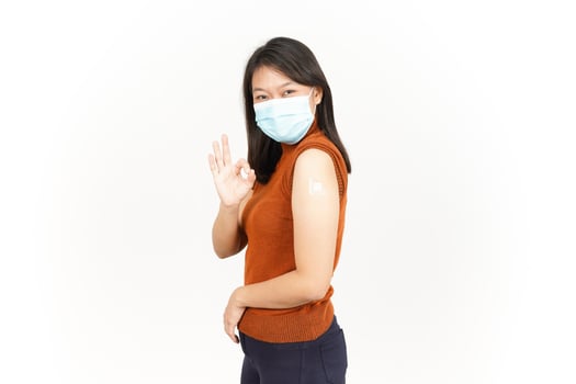 Wearing Mask And Get A Corona Virus Vaccine  Of Beautiful Asian Woman Isolated On White Background photo
