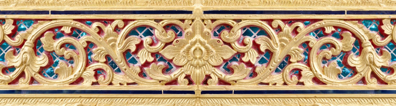 Pattern of gold flower carved on stucco design of native wall, Thai style in temple photo