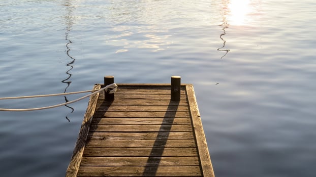 Wooden dock on a lake in the early evening photo
