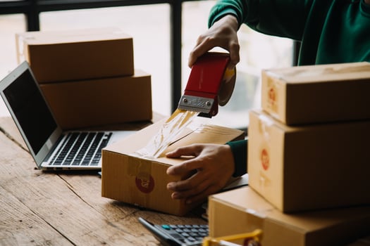 SME entrepreneur Small business entrepreneurs Online selling ideas,Happy Young Asian business owner work on computer and a boxs at home,delivery SME procurement package box deliver to customers, photo