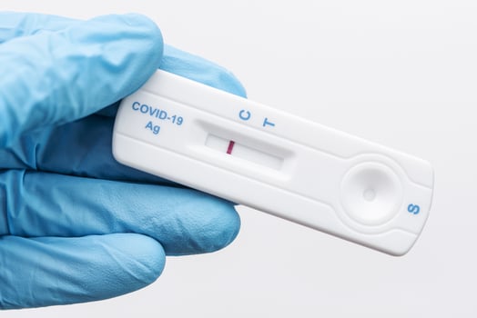 Doctor holding a negative result for COVID-19 with test kit for viral disease. photo