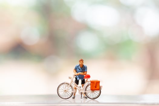 Miniature cyclist standing with bike, World bicycle day concept photo