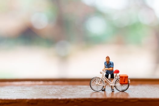 Miniature cyclist standing with bike, World bicycle day concept photo