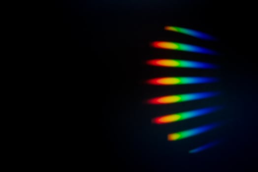 Prism Rainbow Specs on black Background Overlay photo