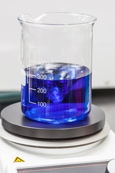 Glass beaker on top of a magnetic laboratory stirrer photo