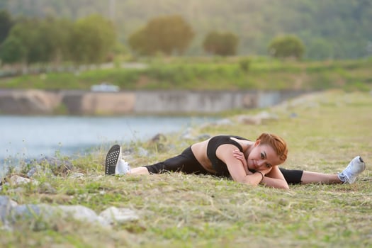 Young girl doing yoga fitness exercise Morning sunrise outdoor in  the meadow beautiful mountains landscape. Meditation and Relax. photo