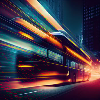 A bus is moving along a city street with long exposures of the lights on the bus and the building behind the train. the bus transportation system, high-speed. photo