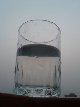 Glass of clear cold water is half full photo