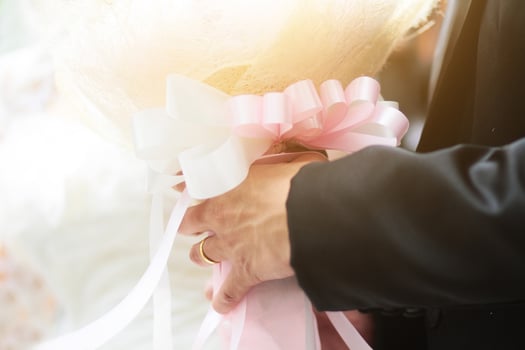 Groom holding rose flowers  bouquet with sunlight in marriage. Valentine Day for love and celebration Concept. photo