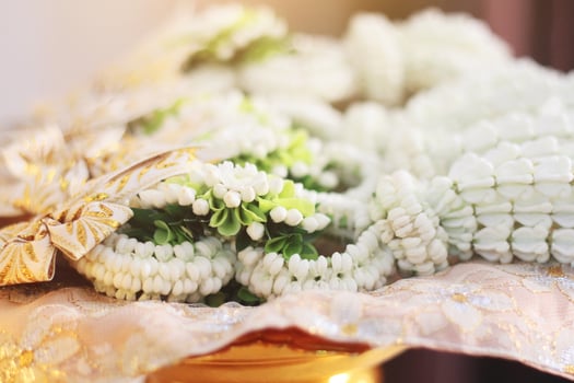 Flower garlands on a gold tray in tradition Thai wedding ceremony day. Jasmine garland. photo