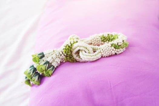 Flower garlands on pink pillow in tradition Thai wedding ceremony day. Jasmine garland photo