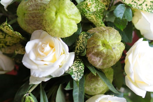 Beautiful blooming White Rose Flowers in vase made of banana leaf in Traditional Thai Art  Decorated Craft Pattern in wedding ceremony traditional. photo