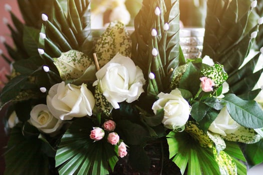 Beautiful blooming White Rose Flowers in vase made of banana leaf in Traditional Thai Art  Decorated Craft Pattern in wedding ceremony traditional. photo