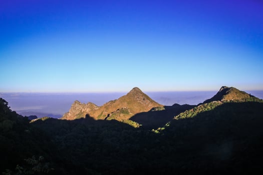 Sunrise in morning with sky and cloud on the Limestone mountain. Sunray with Fog and mist cover the jungle hill in Thailand photo